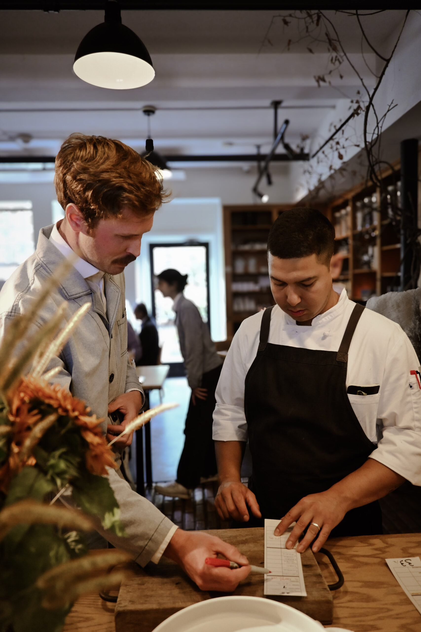Sal and server at the pass
