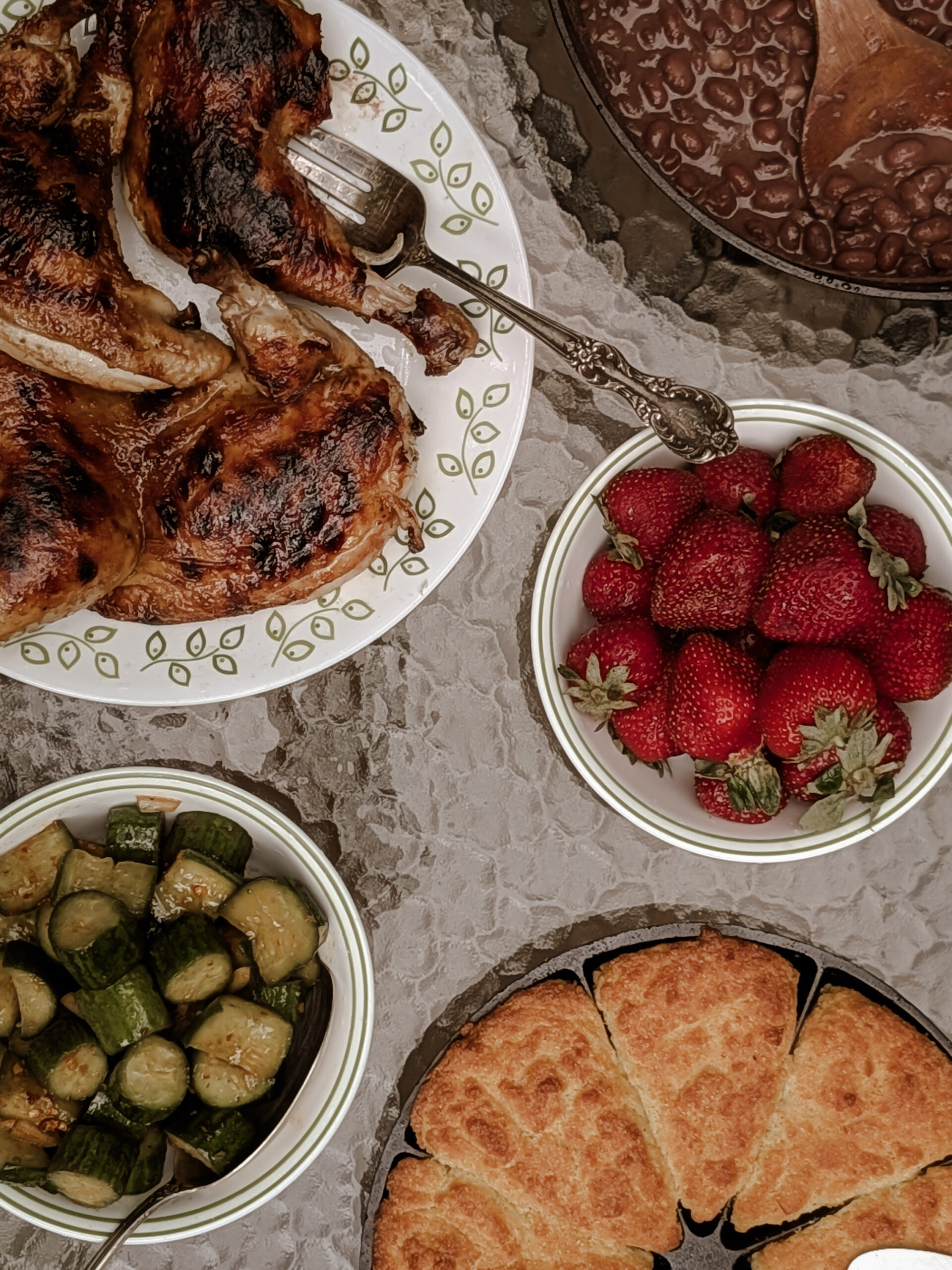 Family-Style Supper: Roasted whole pasture-raised chicken, local strawberries, organic cucumbers, beans cooked over fire