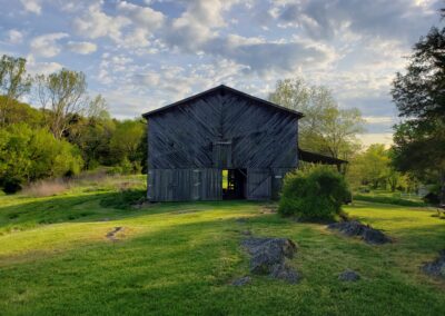 antique barn on 50 acres of fields and forest at golden hour