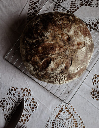 sourdough whole wheat loaf on lace tabletop