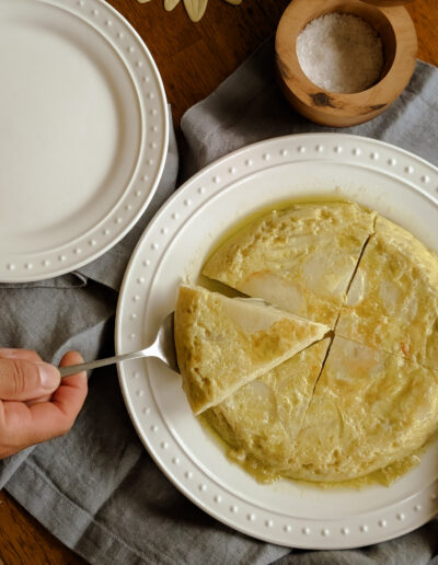 Spanish Omelette being served on white plates